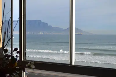a view of the ocean from a window at Zeezicht 303 in Bloubergstrand
