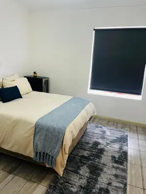 a bedroom with a bed and a large window at Modern secure apartment in Strand - Little Greece in Strand