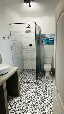 a bathroom with a shower with a toilet and a sink at Winelands guest room in Stellenbosch
