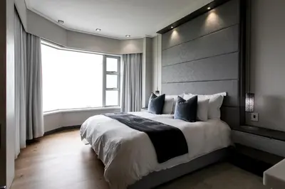 a bedroom with a large bed with a large window at Bayview 303 in Hermanus