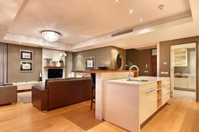 a kitchen and living room with a sink and a counter at The Residences at Crystal Towers in Cape Town