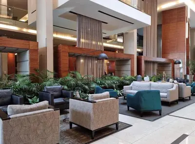 a lobby with couches and chairs and plants at The Residences at Crystal Towers in Cape Town