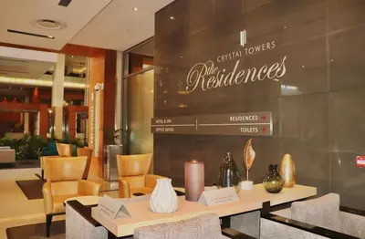 a restaurant with a table with a candle and chairs at The Residences at Crystal Towers in Cape Town
