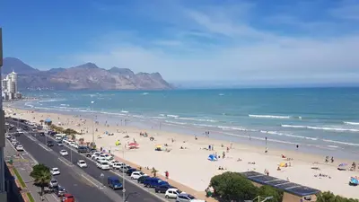 a beach with a lot of people and the ocean at 604 St Tropez in Strand