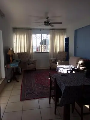 a living room with a table and a couch at Romilly Beach Apartment in Strand
