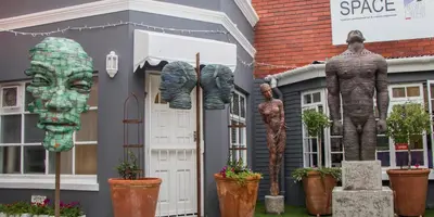 a house with statues in front of it at Zzzone Boutique Hostel in Hermanus
