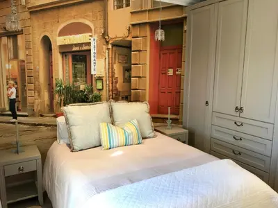 a bedroom with a bed and a red door at Maison Malherbe in Franschhoek