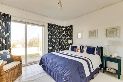 a bedroom with a bed and a window at 42 on 4th in Hermanus
