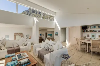 a living room with two white couches and a table at 42 on 4th in Hermanus