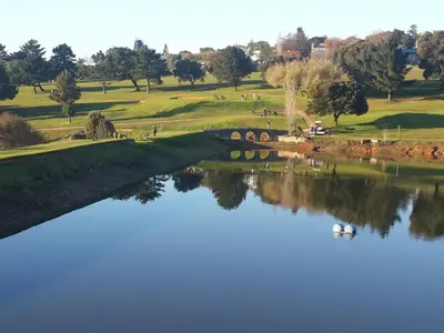 a bridge over a river with a group of golf courses at The Greens Guesthouse in Bellville