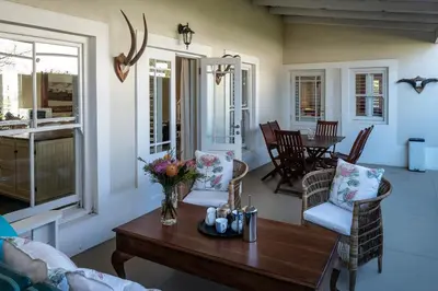 a living room with a table and chairs at Cook's Cottage in Franschhoek