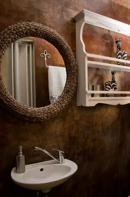 a bathroom with a sink and a mirror at a Vue Guesthouse in Somerset West