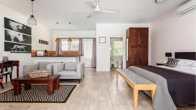 a bedroom with a bed and a living room at Lady Loch Country House in Wellington