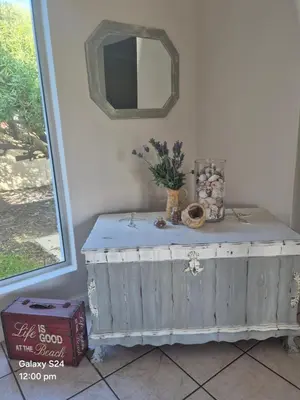 a room with a table with a mirror on the wall at HERMANUS , SANDBAAI holiday house in Hermanus