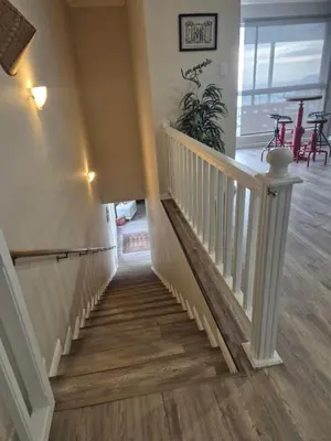 a staircase in a home with wooden floors at HERMANUS , SANDBAAI holiday house in Hermanus
