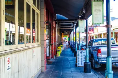 a street with cars parked in front of a building at Cape Town Micro Apartments in Cape Town