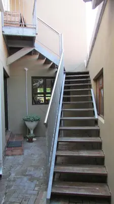 a set of stairs leading to a building at Pinewoods Rest in Somerset West