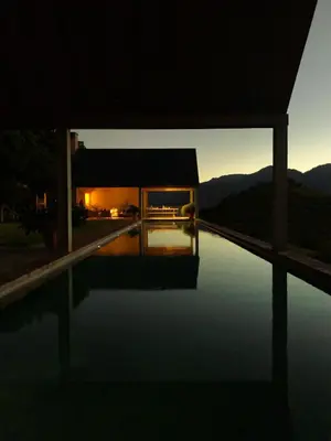 a night view of a house with a pool at 7 Koppies in Franschhoek