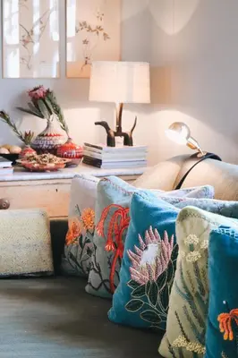 a living room with blue pillows on a couch at 7 Koppies in Franschhoek