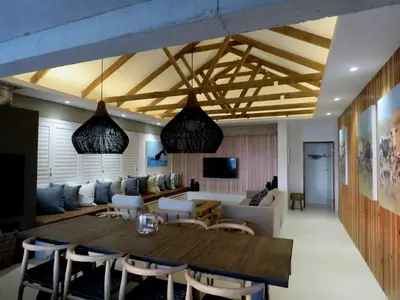 a living room with a table and a couch at Troon Beach Cottage Hermanus in Hermanus