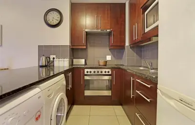 a kitchen with a stove and a dishwasher at Portico 606 in Bloubergstrand
