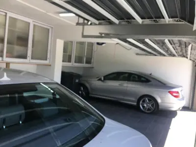 a silver car parked in a garage at GORDON's SHORE LUXURY APARTMENTS - Solar Powered in Gordonʼs Bay