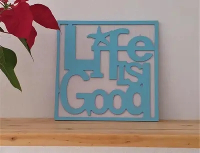 a blue sign that says ate its cool on a shelf at Weavers' Cottage in Gordonʼs Bay