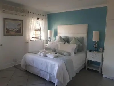 a bedroom with a bed with two towels on it at Alyssa's Inn Boutique Guesthouse in Cape Town