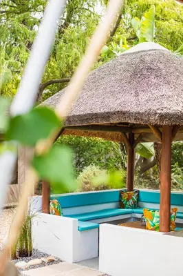 a gazebo with a thatch roof at Khashamongo B & B in Somerset West