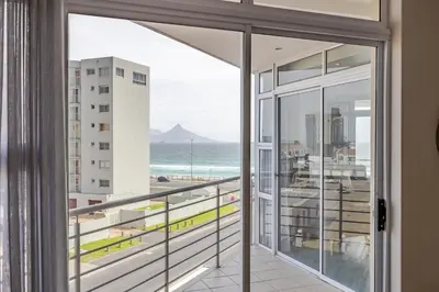 a balcony with a view of the ocean at Luxury Ocean View Beachfront 2 bed apartment -206 The Waves, Blouberg, Cape Town in Bloubergstrand