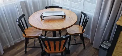 a wooden table with four chairs and a laptop on it at Tranquility in Parow