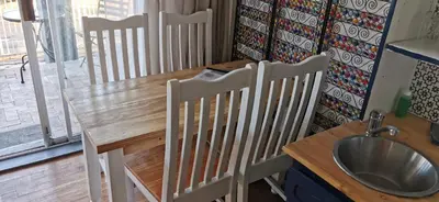a kitchen with a sink and a table and chairs at Tranquility in Parow