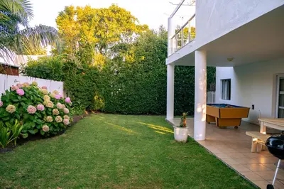 a backyard with a yard with a pool table at Hermanus Family Getaway - Near The Beach in Hermanus