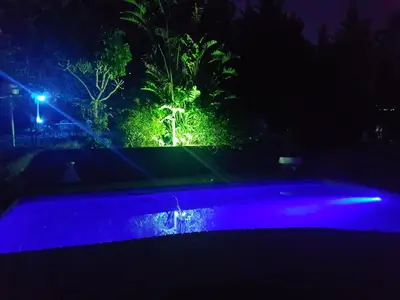 a swimming pool at night with blue lights at Oak on Blair in Somerset West