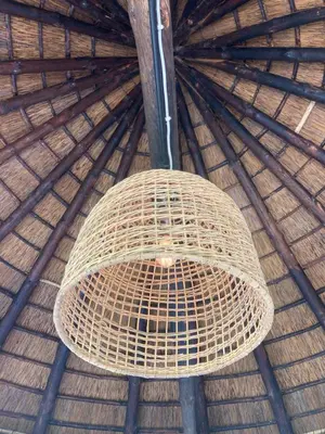 an overhead view of a large wicker basket in a straw roof at Rondawel with sea view in Kleinmond