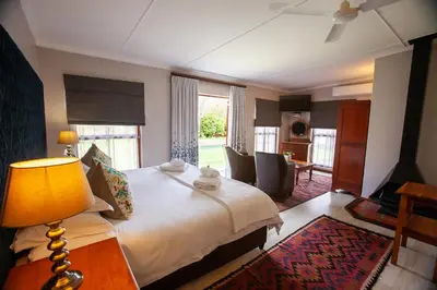 a hotel room with a bed and a living room at The Habit Guesthouse in Worcester