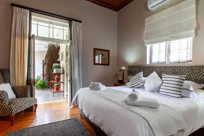 a bedroom with a large white bed with a window at The Habit Guesthouse in Worcester