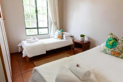 a room with two beds and a window at The Habit Guesthouse in Worcester