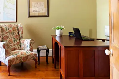 a room with a desk with a laptop and a chair at The Habit Guesthouse in Worcester