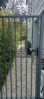 an open gate to a patio in a house at Nerf-af ROOMS at Onrus , Hermanus in Hermanus