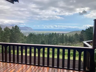 a wooden deck with a view of the mountains at Lalapanzi Lodge in Somerset West