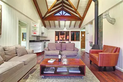 a living room with a couch and a coffee table at Lalapanzi Lodge in Somerset West