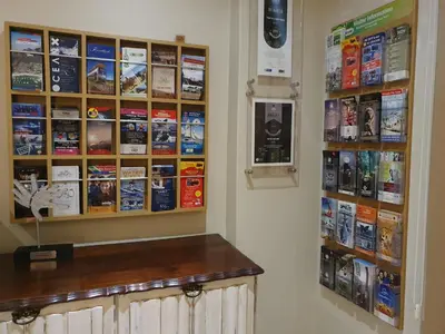 a room with a counter and a wall with books at Tyger Hills Guest House in Bellville