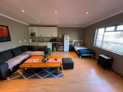 a living room with a couch and a table at 3 on Nebraska Accommodation in Bellville