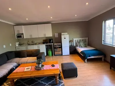 a living room with a couch and a table and a kitchen at 3 on Nebraska Accommodation in Bellville