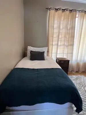 a bedroom with a bed with a black and white blanket at 3 on Nebraska Accommodation in Bellville