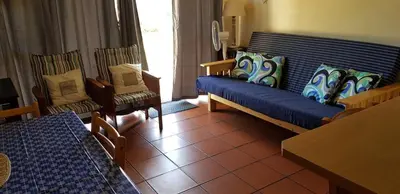 a living room with a couch and two chairs at 123 hbc in Hermanus