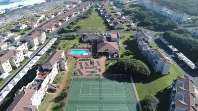 an aerial view of a house with a tennis court at 123 hbc in Hermanus
