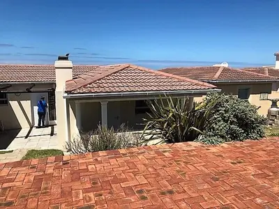 a person standing in the doorway of a house at 123 hbc in Hermanus