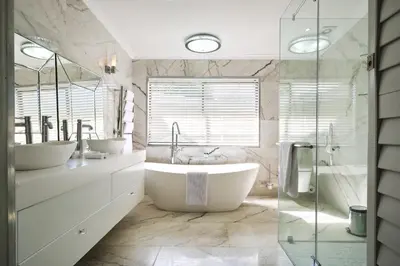 a bathroom with two sinks and a large tub at Alluvia Boutique Winery & Luxury Accommodation in Stellenbosch